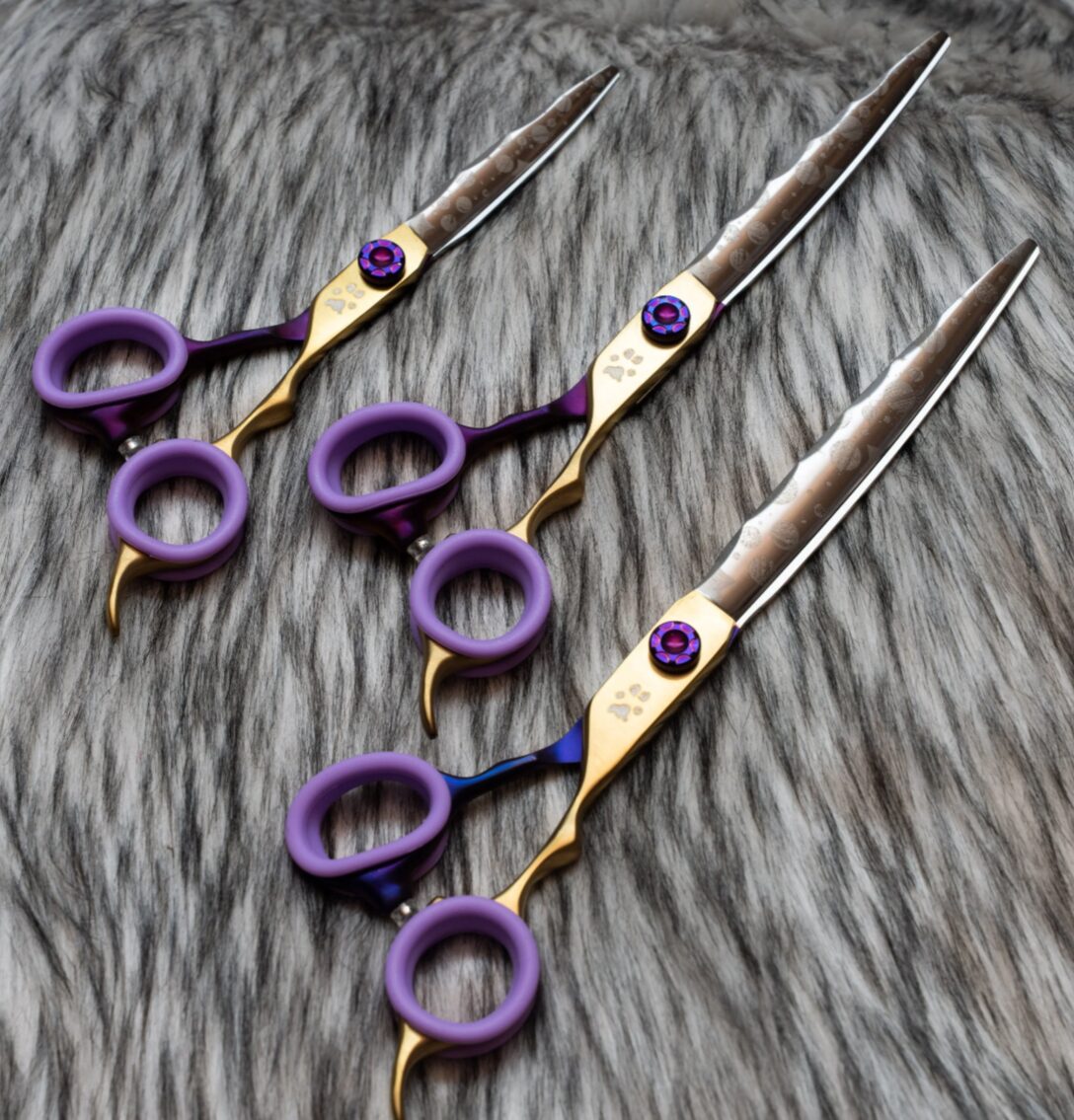 Nebula straight dog grooming shears sitting on fur for professional dog groomers.
